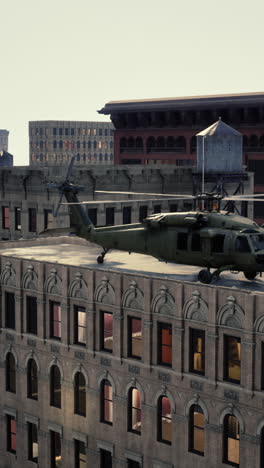 military helicopter on rooftop of a city building