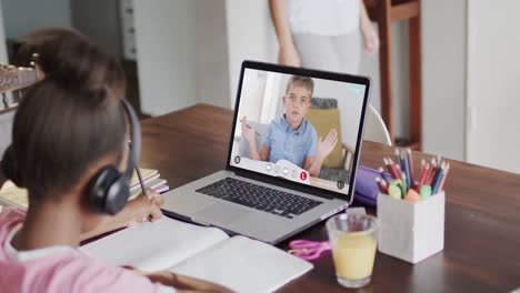 Diverse-schoolgirl-having-class-on-laptop-video-call-with-her-friend-in-slow-motion