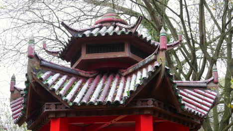 a chinese garden building in winter with frost and snow on the roof