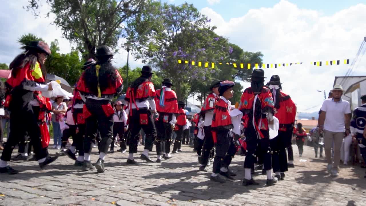 Slow motion shot of Peruvian children in red and white dress dancing and enjoying at folk music at Huancayo.