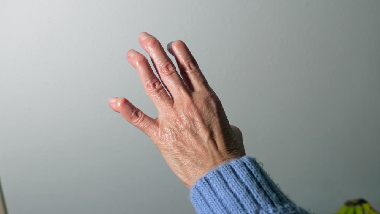 Hand in blue sweater