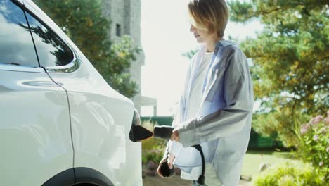 woman charging electric car