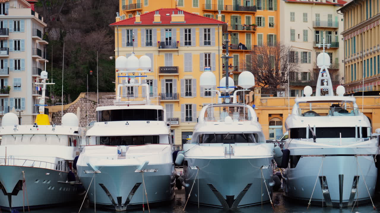 Nice, France - February 4, 2025: White boats docked in Port Lympia, overlooking the city