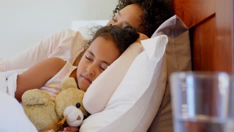 front view of black mother and daughter sleeping in bedroom at home 4k