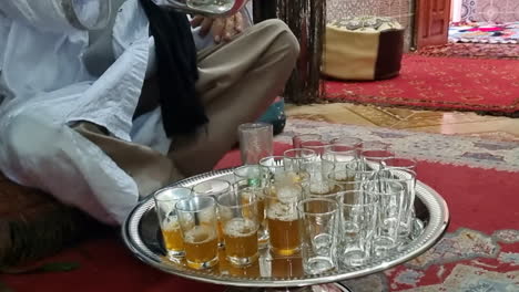 shot of a man serving tea in the city of ayoun