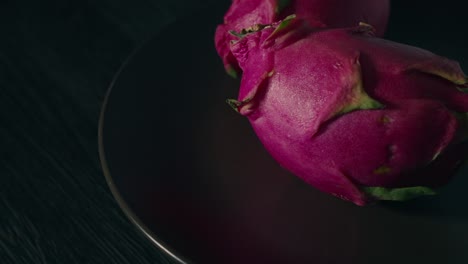 dragon fruit spinning on a plate with a dark background