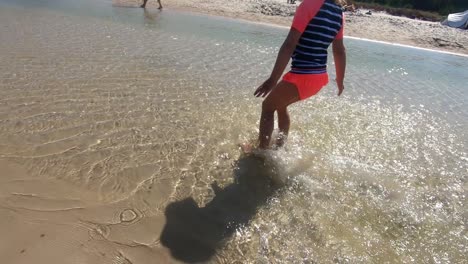 child running in water splashing. baltic sea, poland