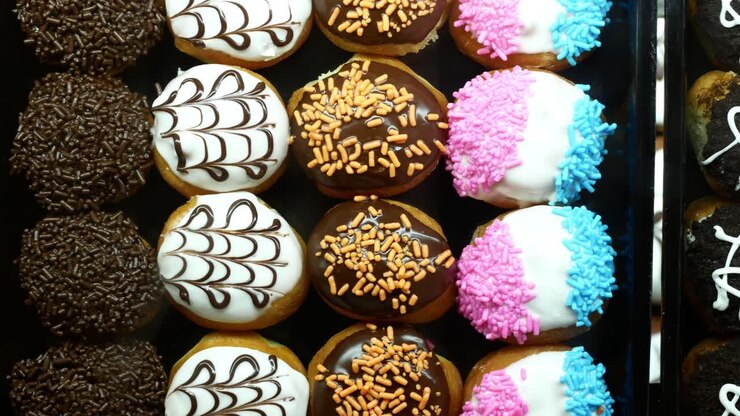 Chocolate donuts display for sale at local store ,