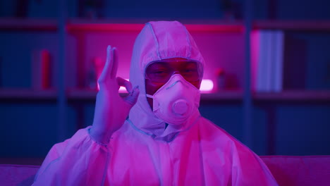 person in protective gear showing peace sign