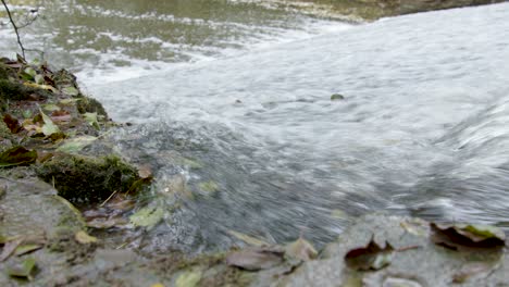 close up water flow of the leigh brook flowing through the knapp and paper-mill abberley and malvern hills geopark