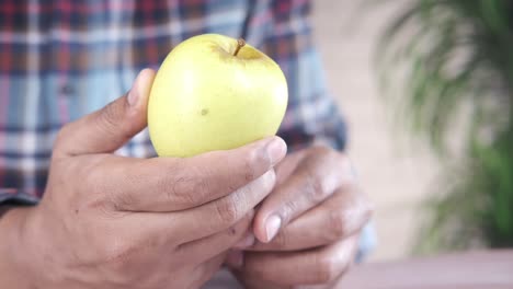 person holding a yellow apple