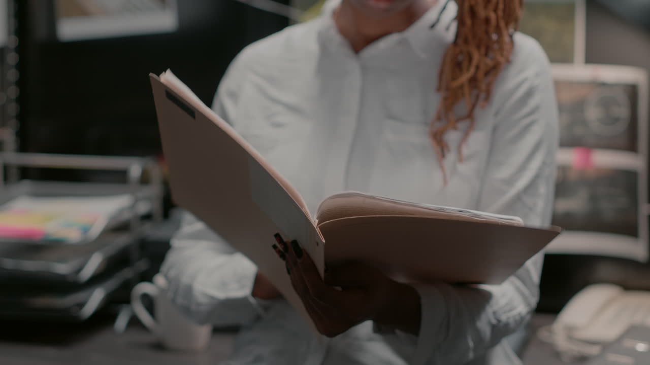 Investigator reviewing case file in office