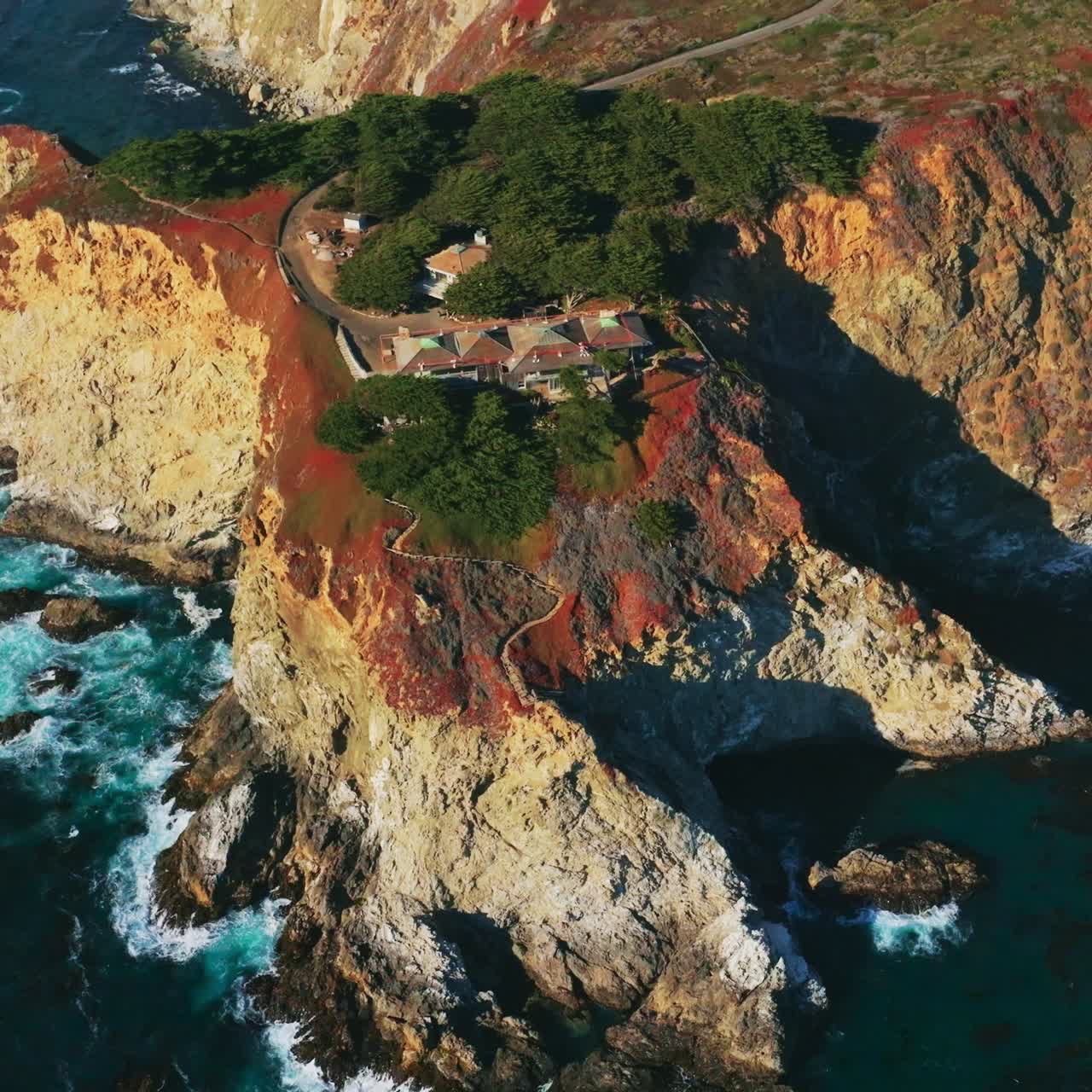 Splendid high rocks at the shore with houses on the tops. Beautiful landmark at California coastline. Top view