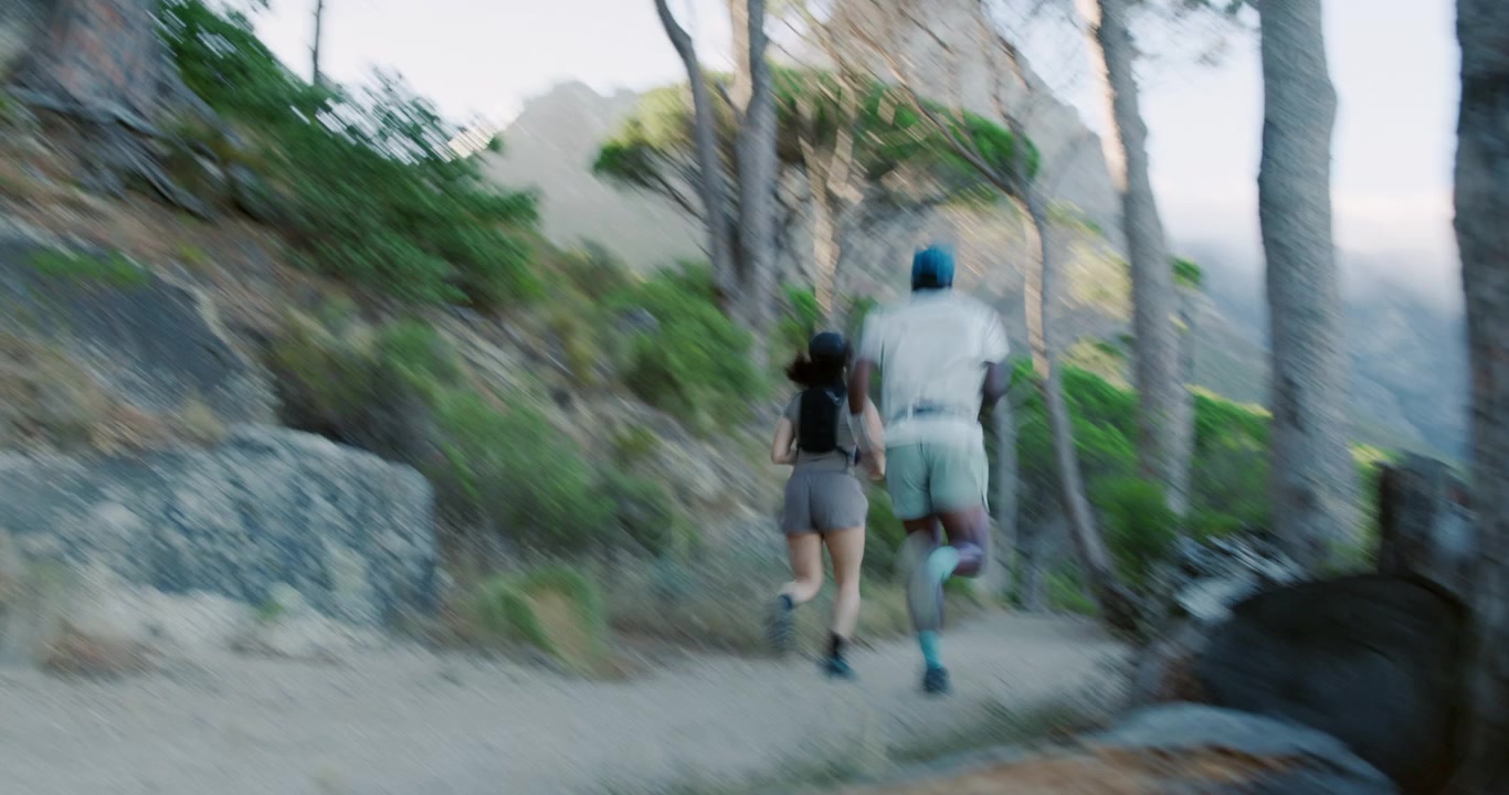 Two Athletes Running on a Scenic Mountain Trail