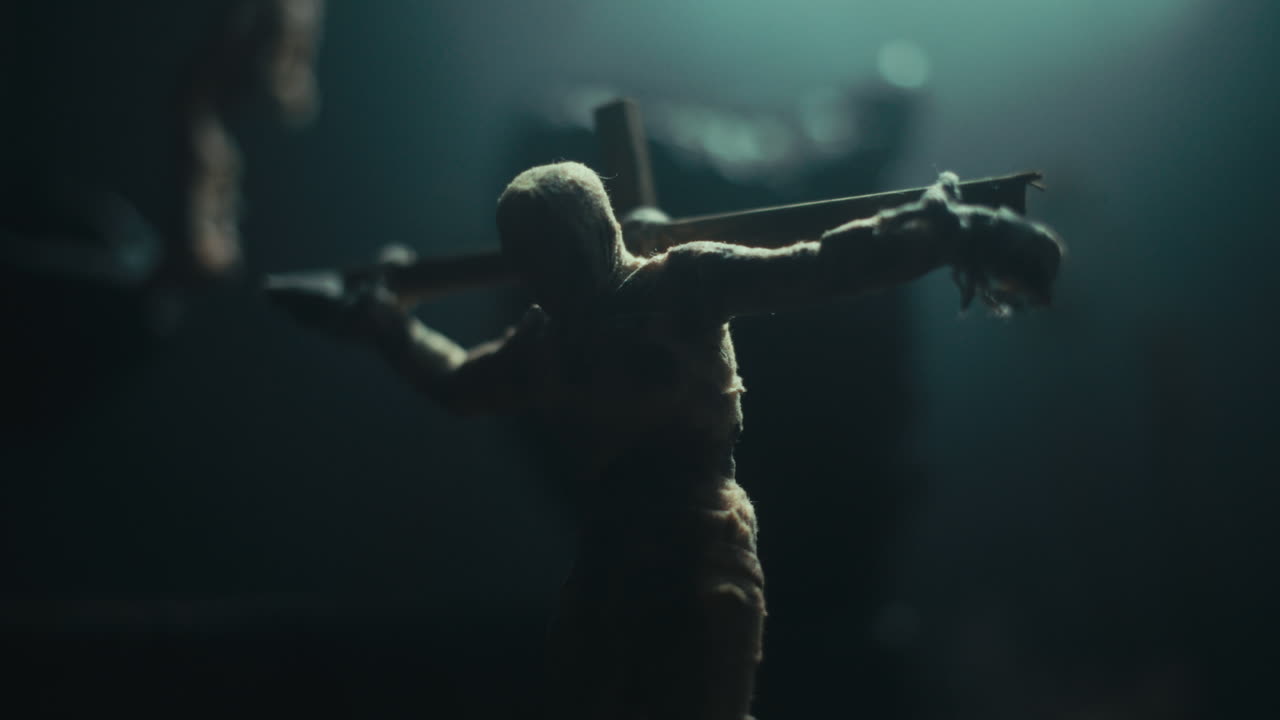 Miniature mummified dolls hanging on the gallows at night