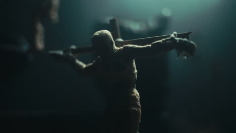 miniature mummified dolls hanging on the gallows at night