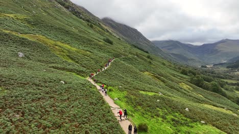 4K-Aerial-flyover-of-group-of-hikers-ascending-to-Ben-Nevis-mountain