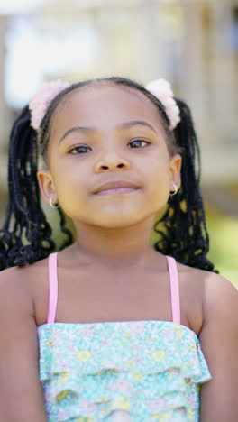 vertical video of portrait of happy african american girl, in slow motion