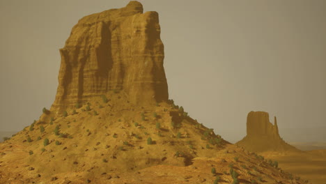 exploring majestic rock formations under a dusty sky in a desert landscape