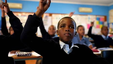 schoolkids hand raised in the classroom 4k