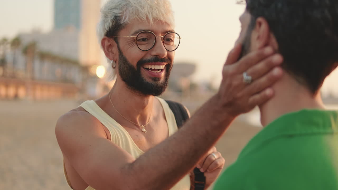 Happy Gay Couple Laughing and Showing Affection on City Beach