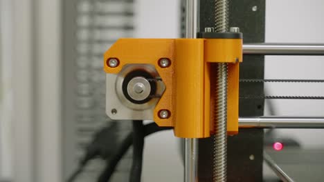 graded, detail od 3d printer´s orange side rails moving and rotating