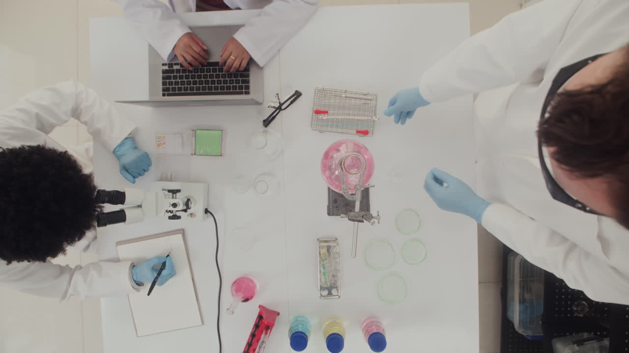 Chemists Working with Reagents at Laboratory Top View