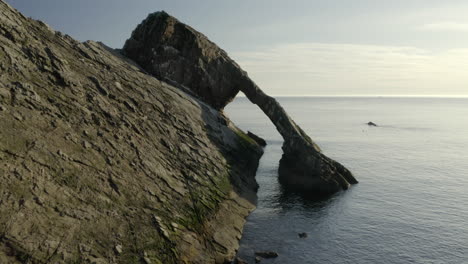 An-aerial-view-of-Bow-Fiddle-Rock-at-Portknockie-on-a-calm-summer's-morning