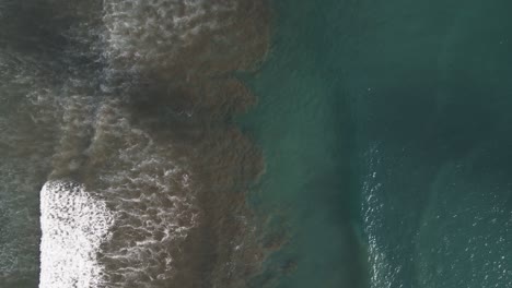 Aerial-View-Of-Waves-sitting-the-shore-of-Dominical-Beach-In-Costa-Rica,-Static-Wide-Shot