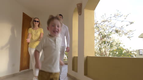 parents and child in hotel corridor