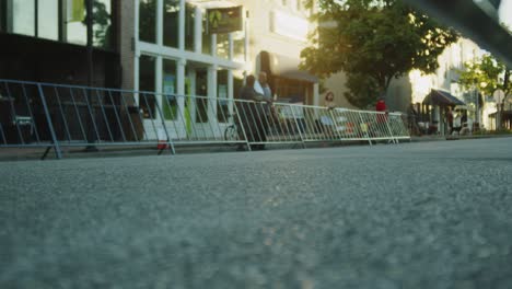 Bicyclists-riding-at-a-slower-pace-during-a-race-in-the-afternoon-with-camera-low-on-the-ground