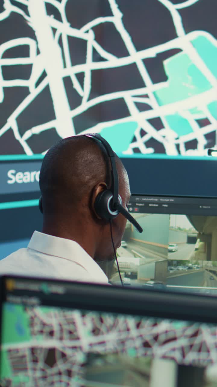 African American Man Monitoring Traffic on Computer Screens in Control Room