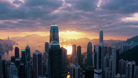 dramatic sunset over hong kong city skyline and harbor