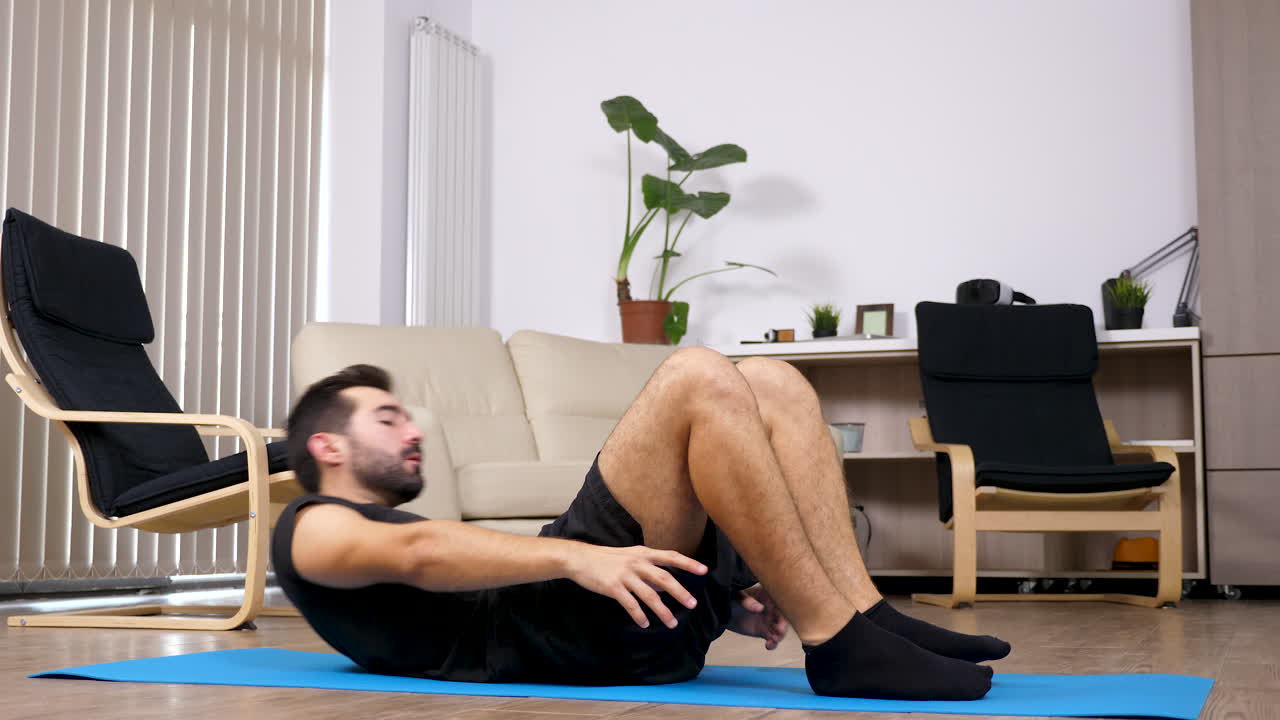 Man doing sit-ups exercise at home