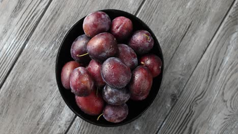 bowl of wet ripe plums