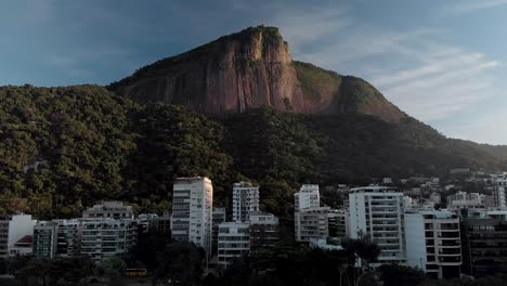 slow upwards aerial movement showing the corcovado mountain in rio de janeiro seen from the city lake at sunrise