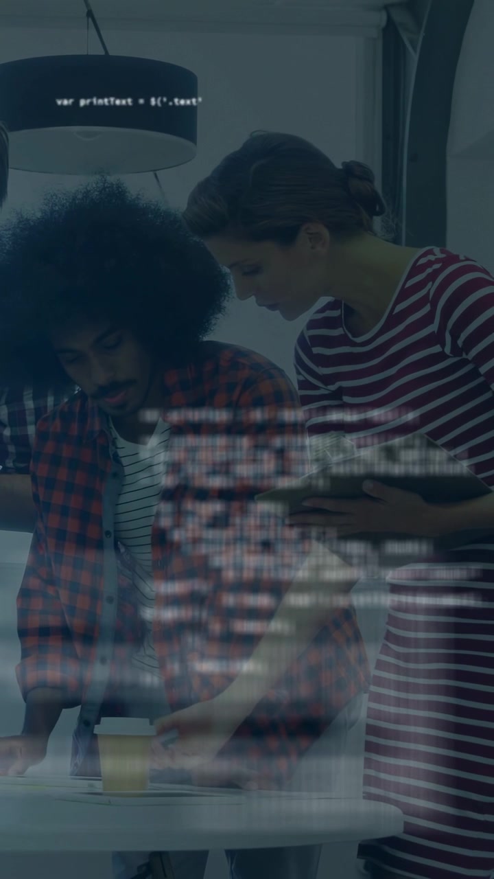 Vertical video: Team checking device on round table, code appearing on glass, aiding tech review