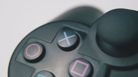 joystick-with-symbols-on-buttons-on-light-surface-macro