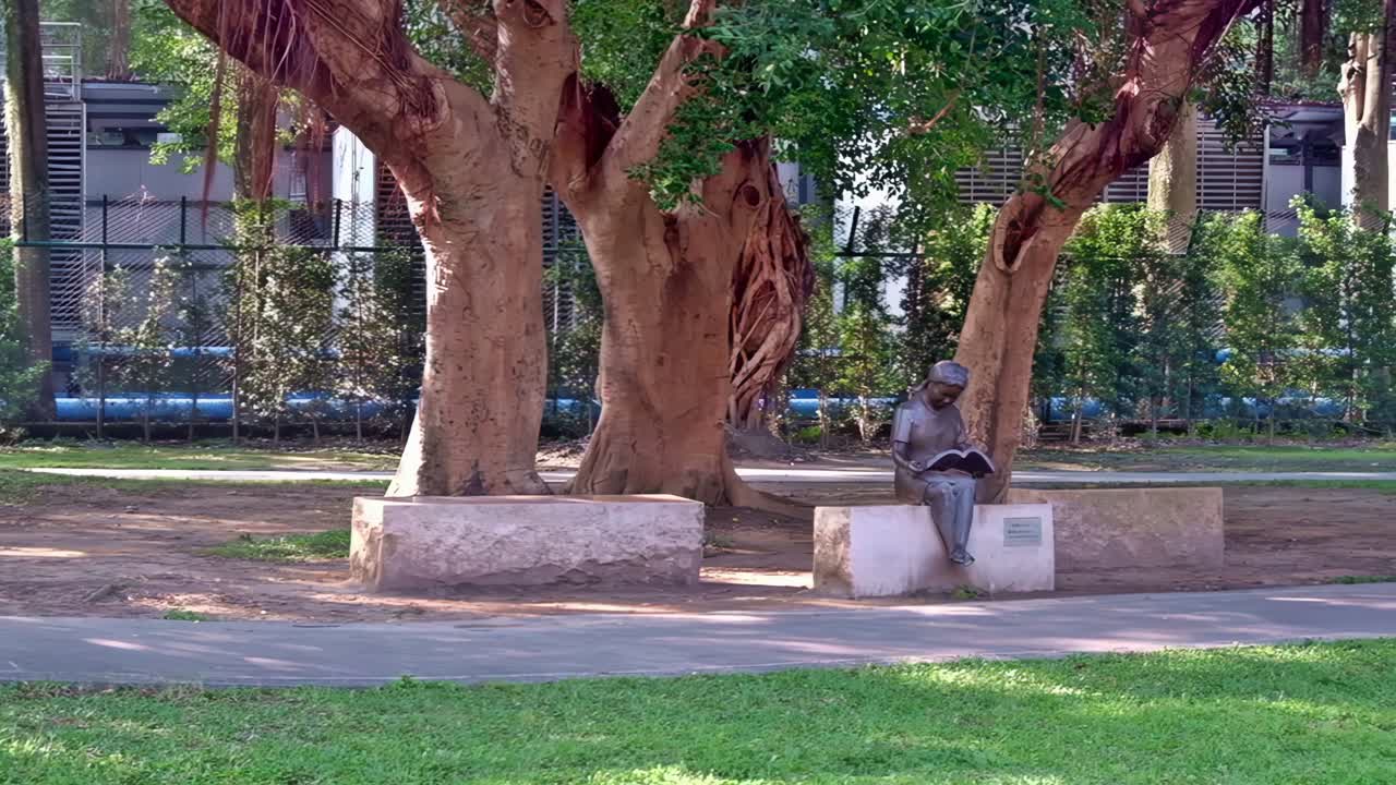 Sculpture of a girl reading at a park along the walkway to the National Sun Yat-sen Memorial Hall in Taipei.