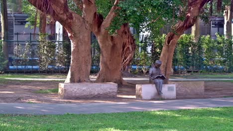 sculpture of a girl reading at a park along the walkway to the national sun yat-sen memorial hall in taipei.