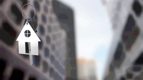 animation of silver house key fob and key, hanging in front of blurred city high rise buildings