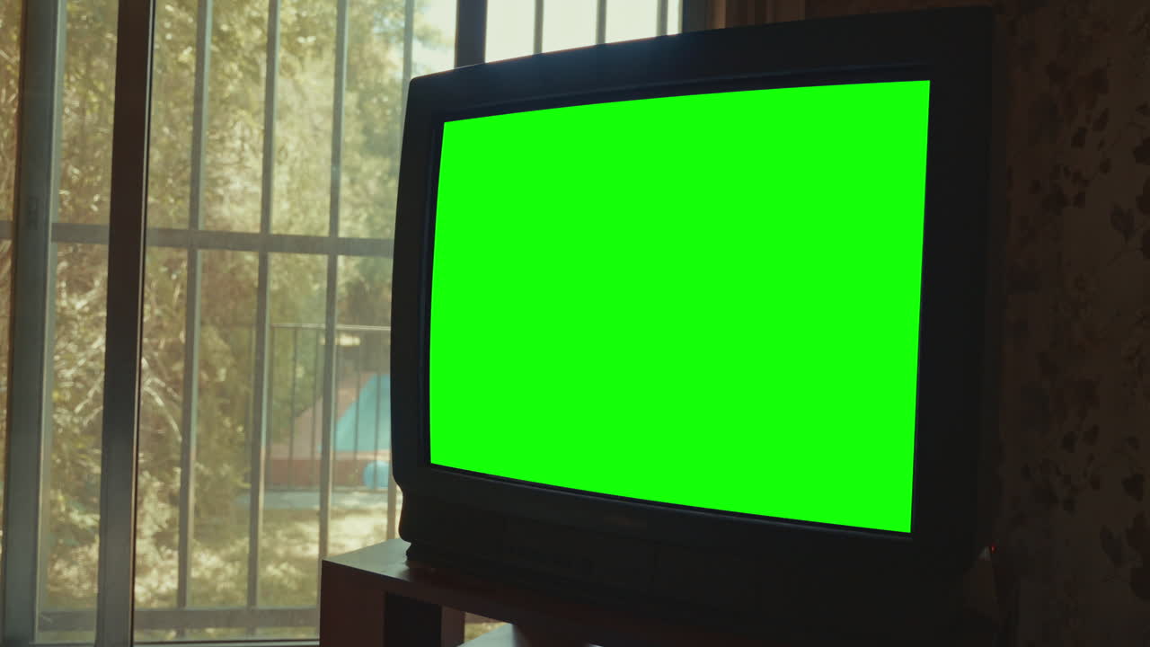 Retro CRT TV with Green Screen Display by a Window
