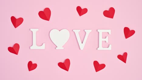 moving red hearts around love text. valentine's day stop motion animation