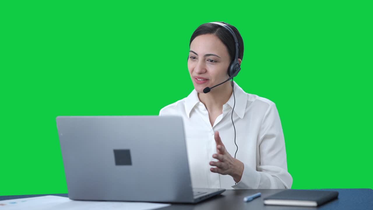 Happy indian call center girl talking to customer through call green ...