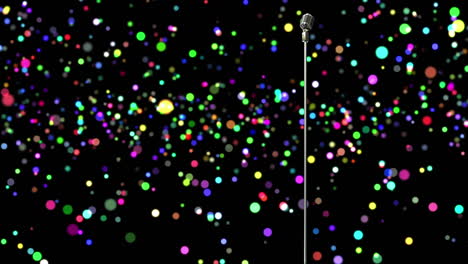 retro metallic microphone against colorful spots of light against black background