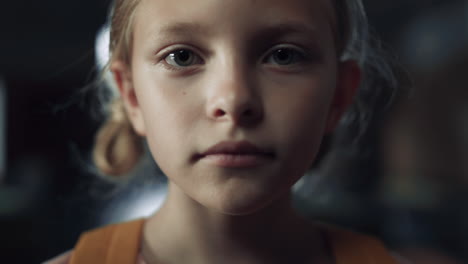 closeup face frightened girl in dark hall. schoolgirl standing school corridor.