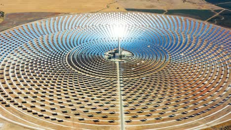 solar panels circular power plants with the reflection of the sunlight in the panels to produce renewable and pollution-free energy - aerial view with a drone - environmental concept