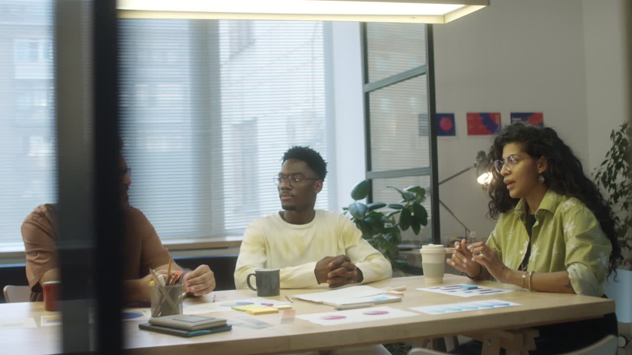 Female Team Leader Talking to Colleagues