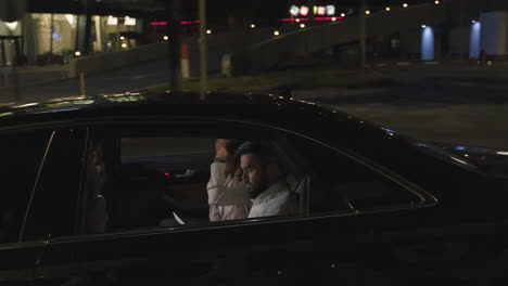 business-like people in taxi at night