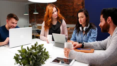 business executives discussing over digital tablet